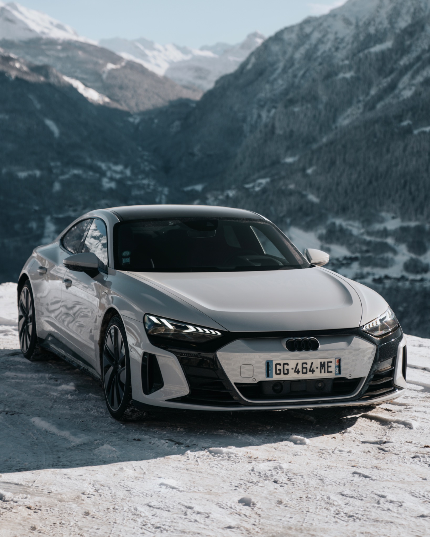 White Audi in the snow with mountain landscape for Fusalp X Audi