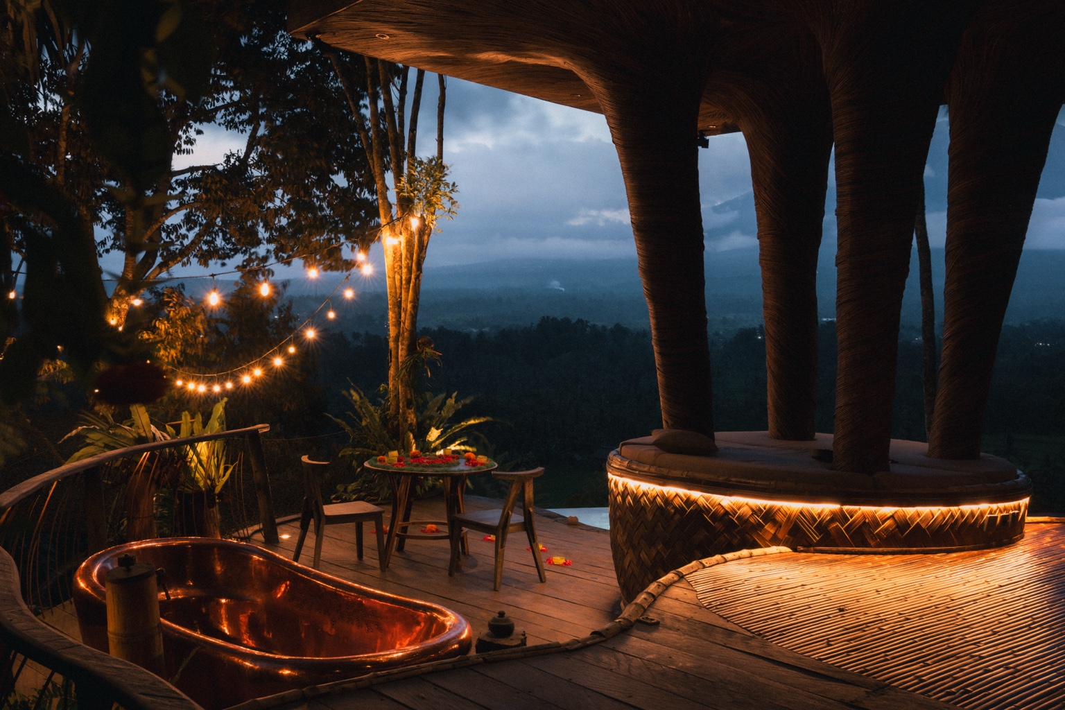 Hideout Bali copper bathtub and evening jungle view