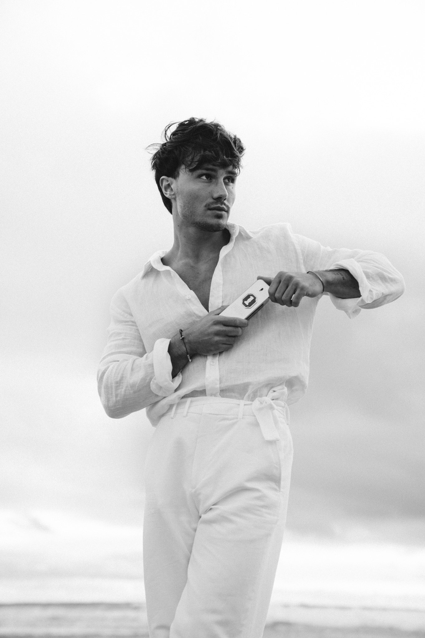 Paco Rabanne black and white portrait holding the fragrance